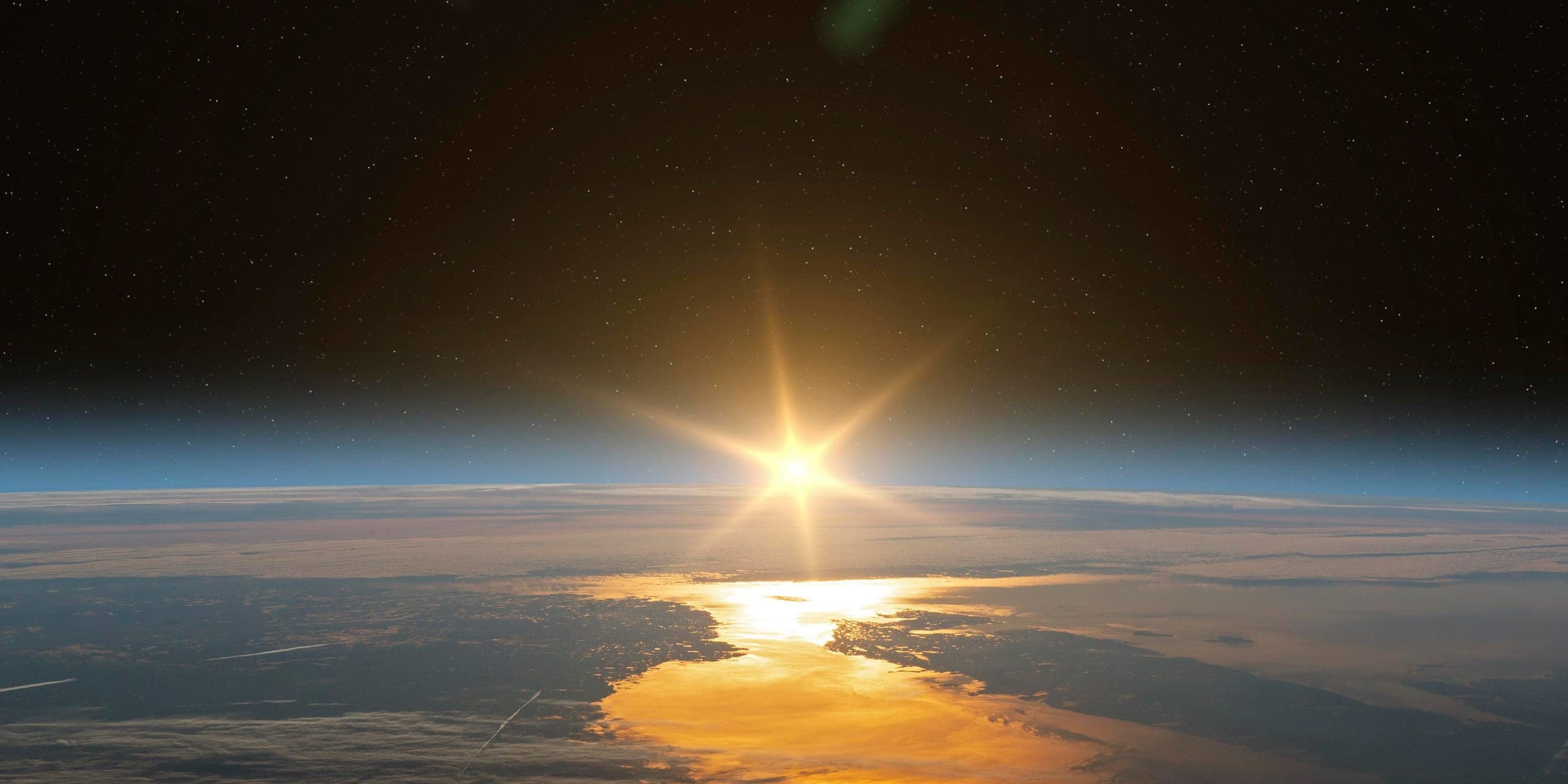 Sun rising over the Earth seen from space